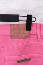 Pink denim pants with belt-loop waistband and small rectangular logo label