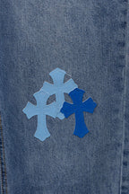 Light blue denim fabric with a large blue cross applique