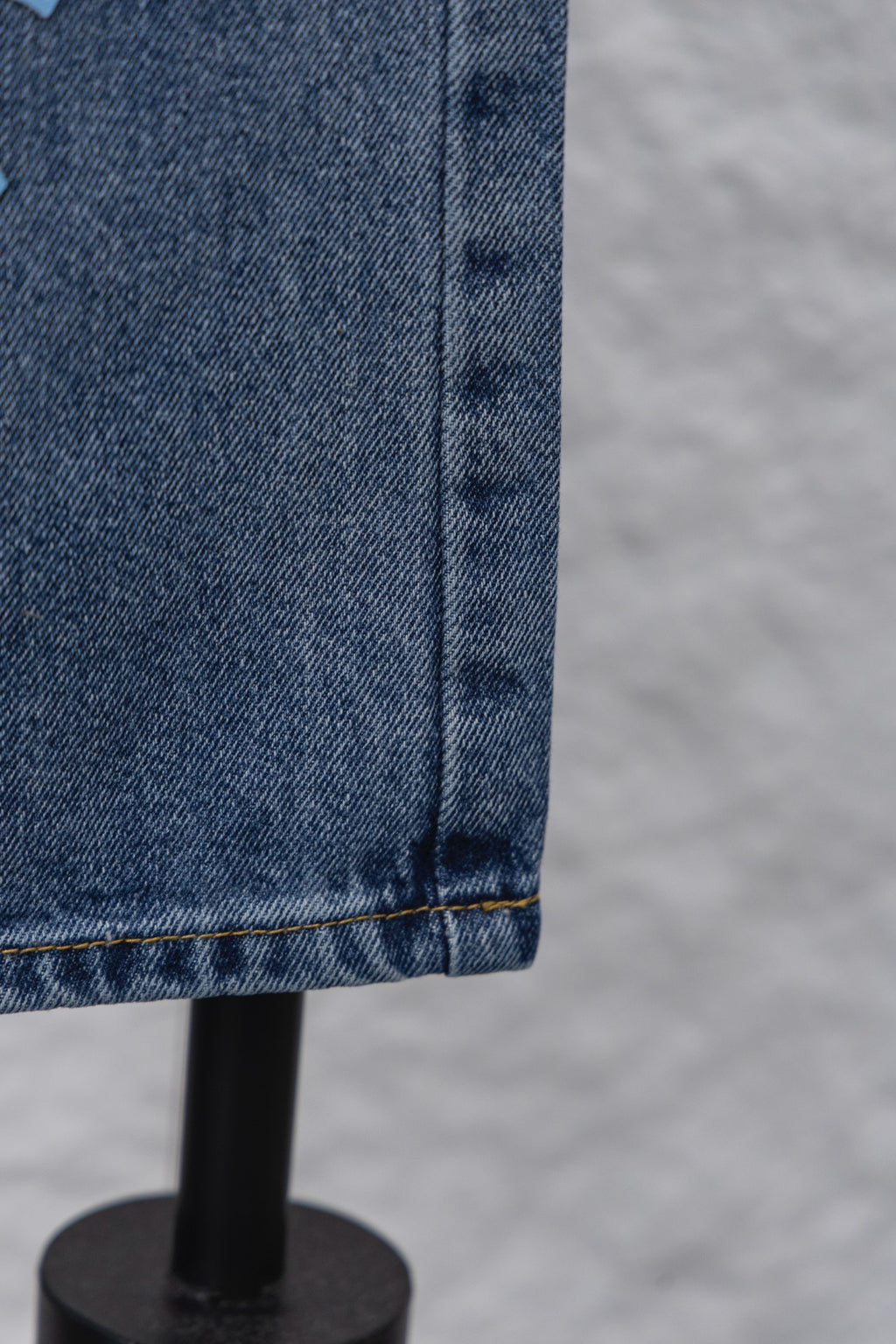 Denim pants hem with seam stitching and folded cuff
