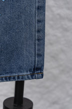 Denim pants hem with seam stitching and folded cuff