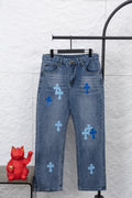 Light blue denim pants with multiple blue cross patches on the legs