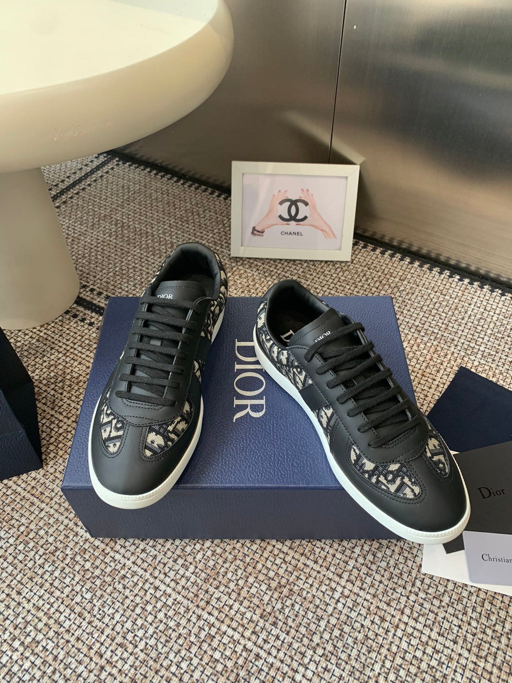 Dior unisex low-top sneakers pair view, black patterned uppers and white soles