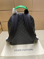 Louis Vuitton monogram mini backpack shown from back with green handle