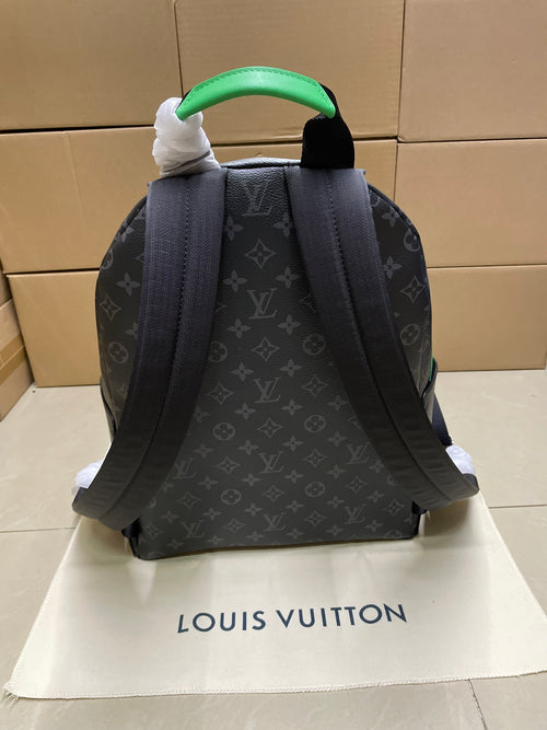 Louis Vuitton monogram mini backpack shown from back with green handle