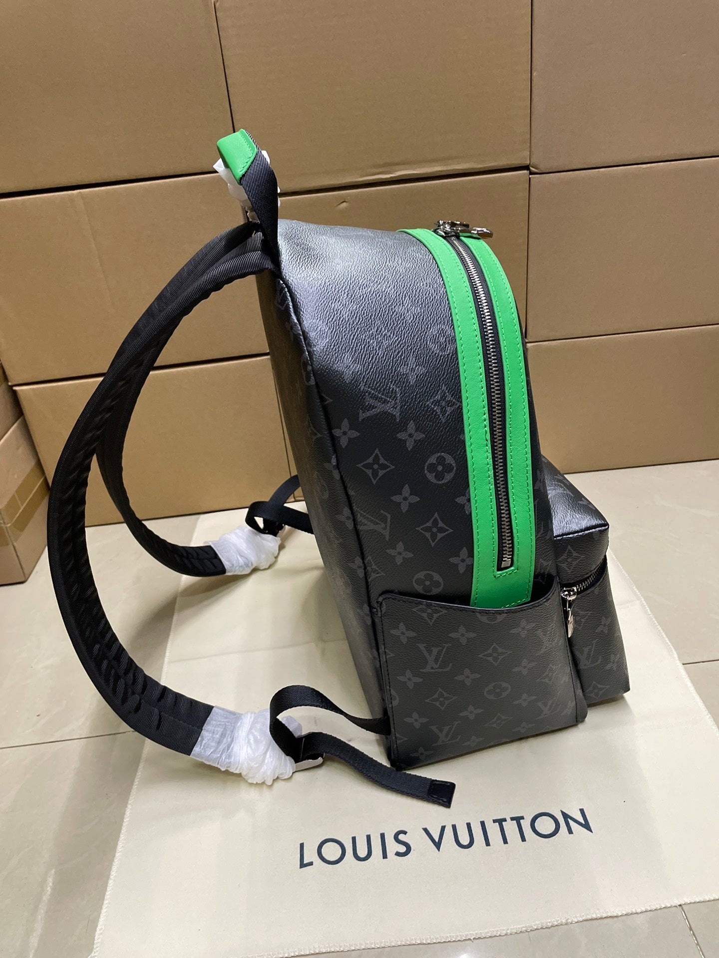 Louis Vuitton monogram mini backpack side view with green-trim pocket