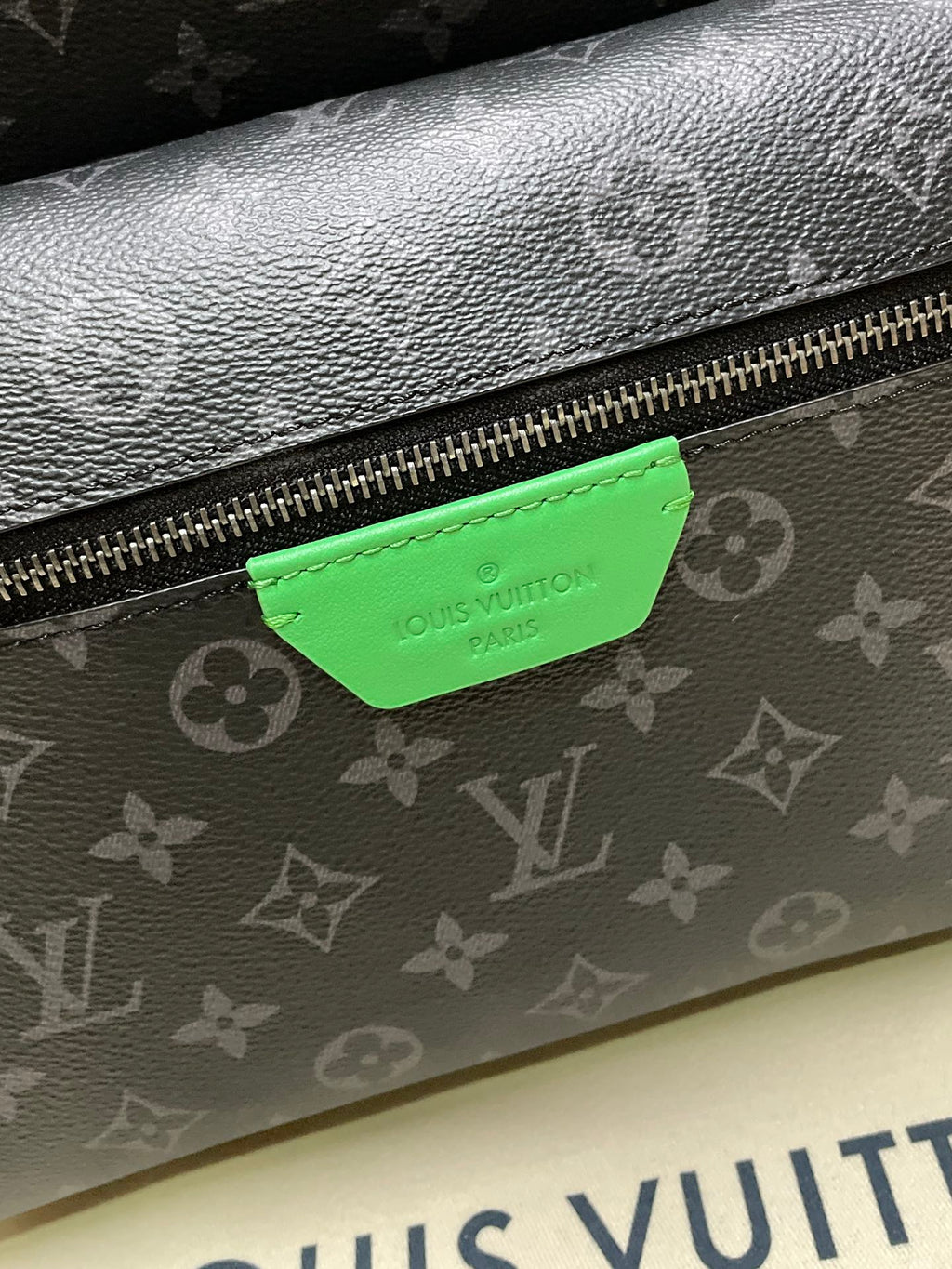 Louis Vuitton monogram bag front zipper with green leather brand tag
