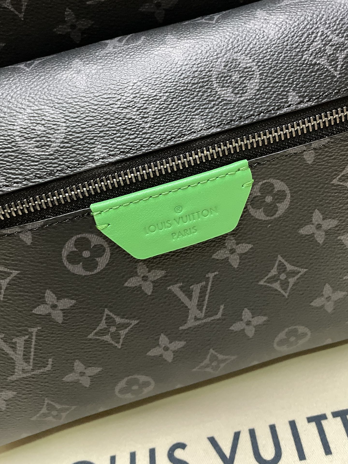 Louis Vuitton monogram bag front zipper with green leather brand tag