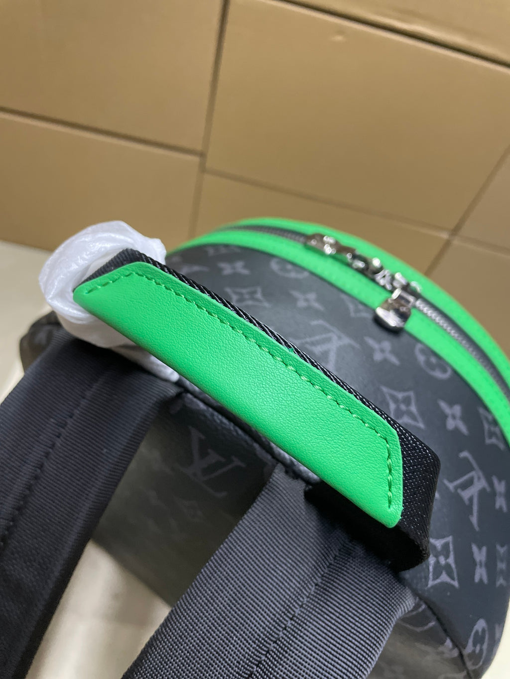Louis Vuitton mini backpack close-up of green strap panel and monogram