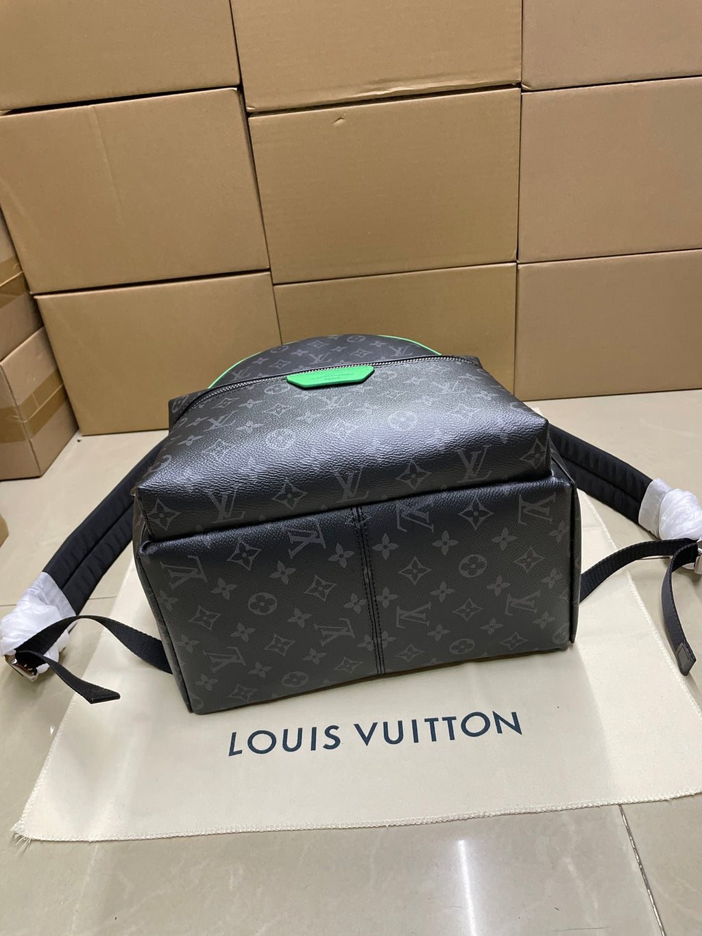 Louis Vuitton monogram mini backpack angled front with green top patch