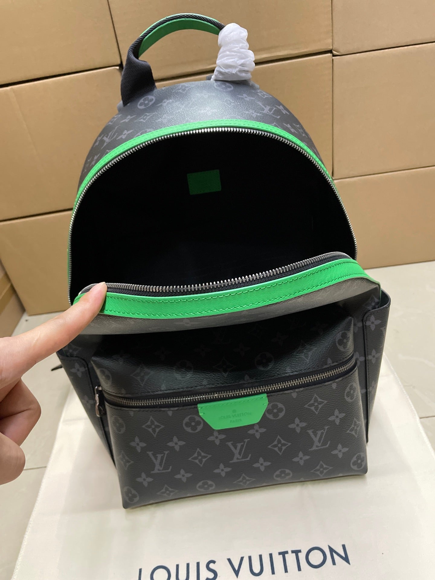 Louis Vuitton monogram mini backpack with open top showing green-lined interior