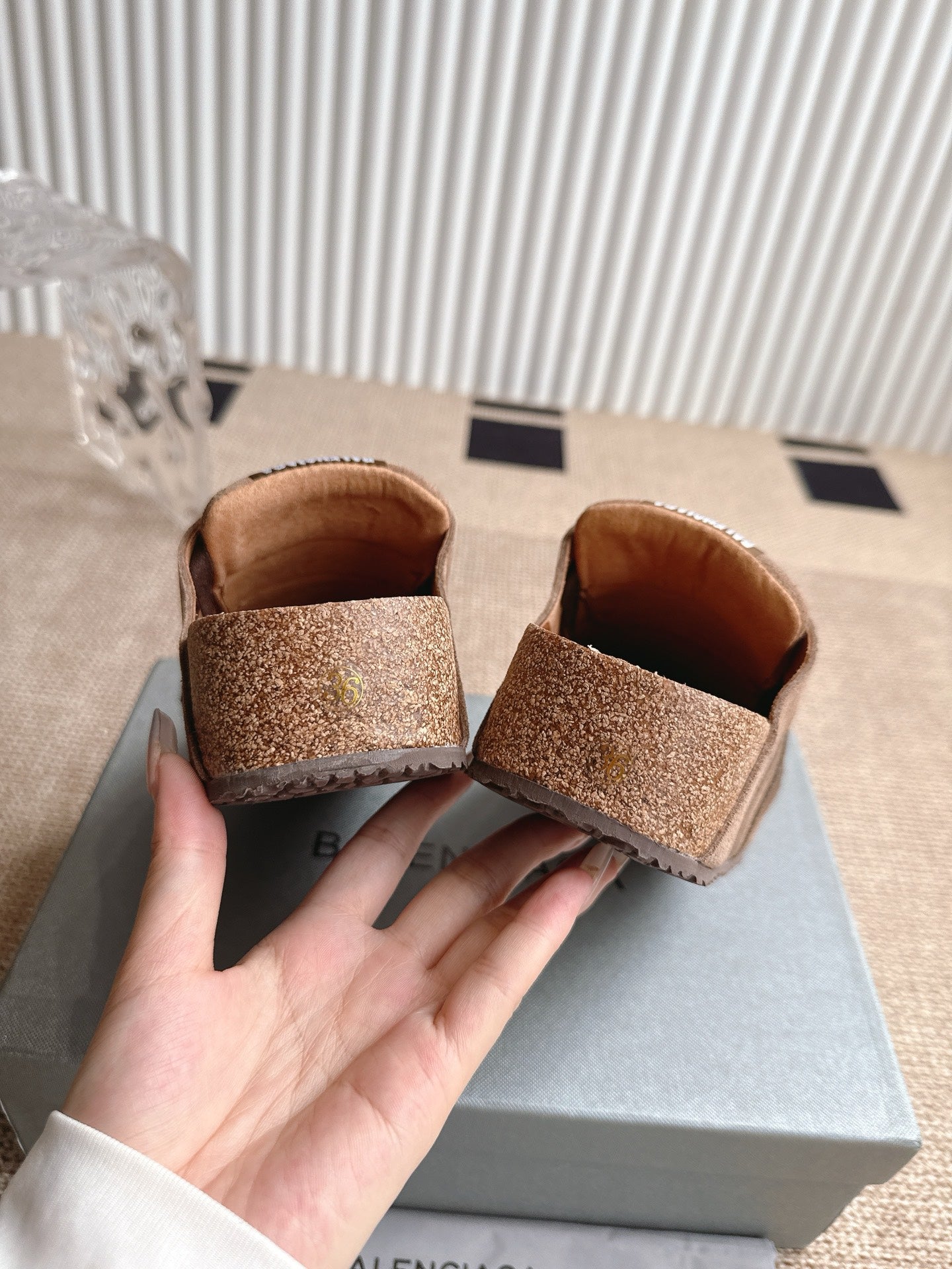 Brown suede sandals showing interior lining at heel, two shoes