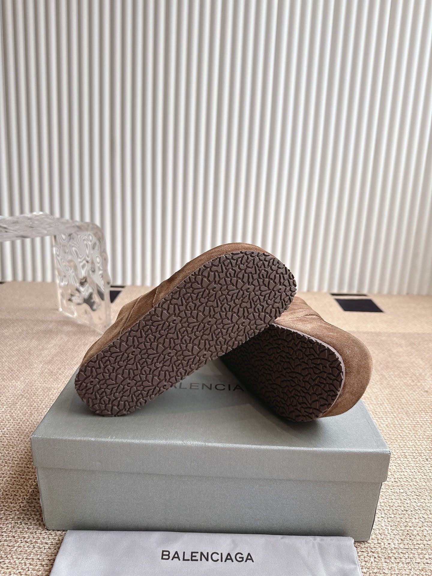 Brown suede sandals with textured rubber outsole, heel side view