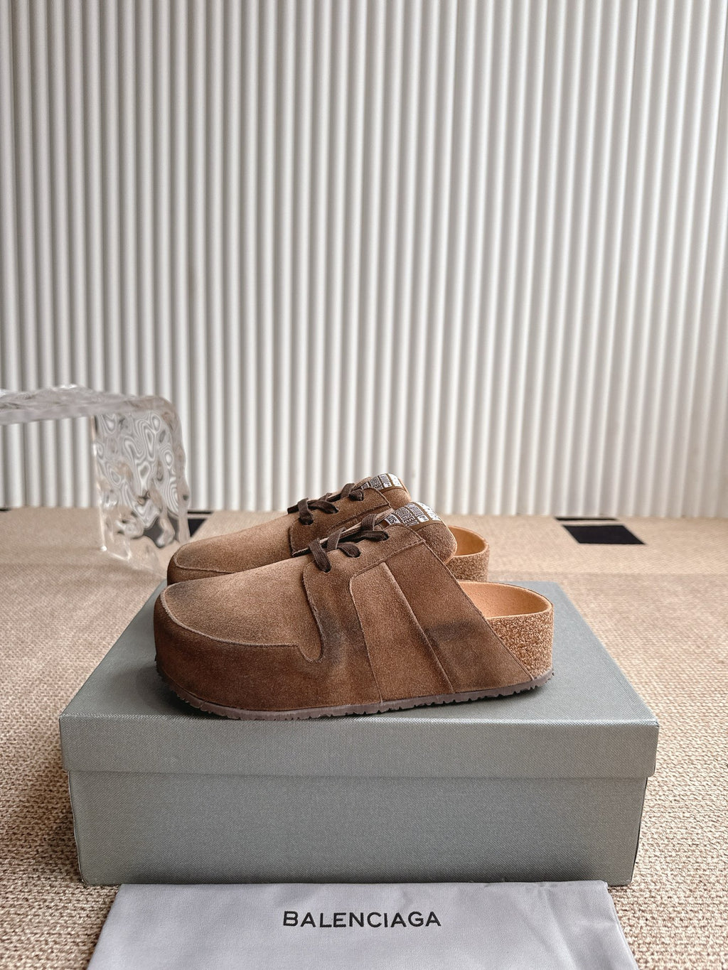 Brown suede mule-style sandals with lace-up front and open top