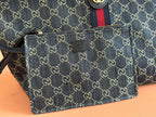 Small monogram pouch accessory with zipper and leather strap attached to the tote bag