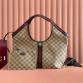 Gucci bag with beige GG canvas, green/red web stripe, dual top handles, structured silhouette