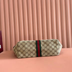 Gucci bag with beige GG canvas, green/red web stripe, rectangular body, top handle view