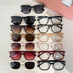 Assorted sunglasses flat lay with black, white, tortoiseshell, and colored frames