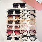 Assorted sunglasses flat lay with multiple frame colors and tinted lenses
