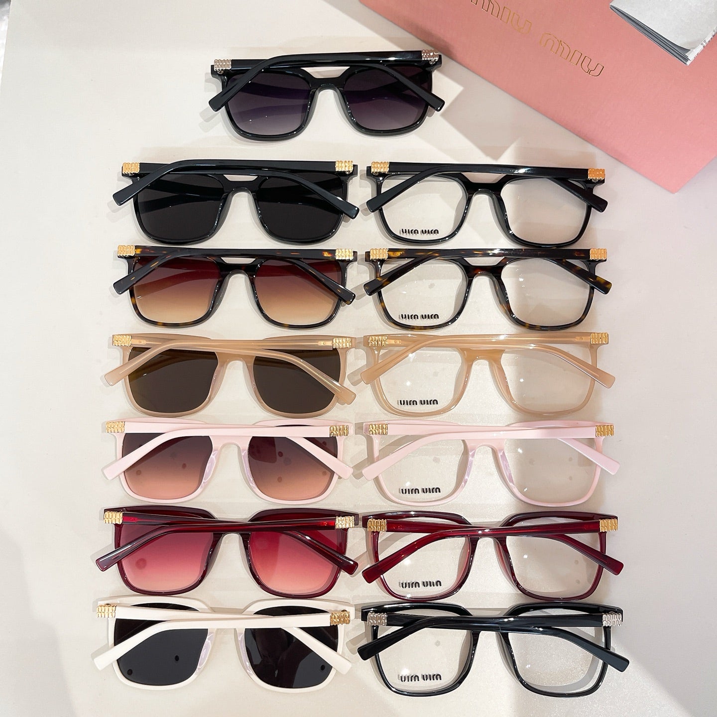 Assorted sunglasses flat lay with multiple frame colors and tinted lenses