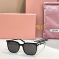 Sunglasses with black square frames and dark tinted lenses, metal accents on temples