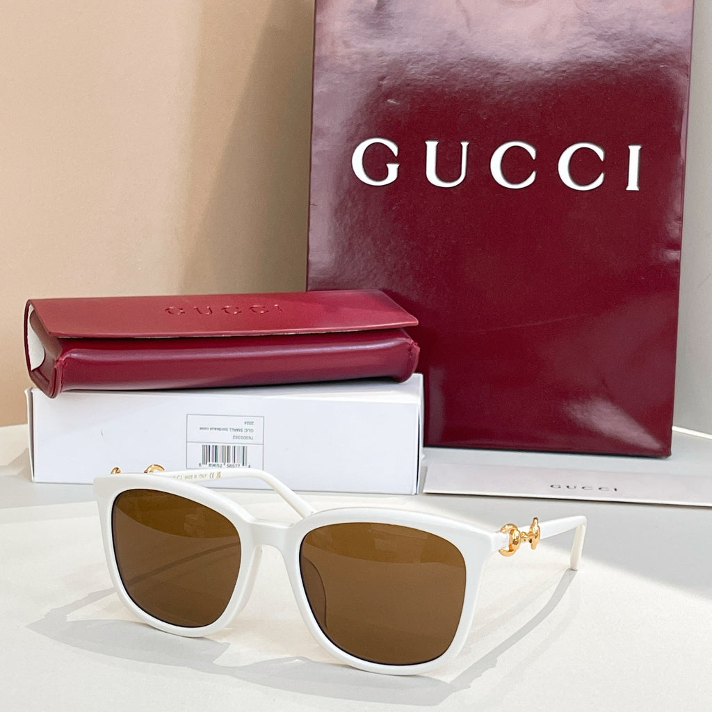 Gucci sunglasses with white frames and tan-brown tinted lenses