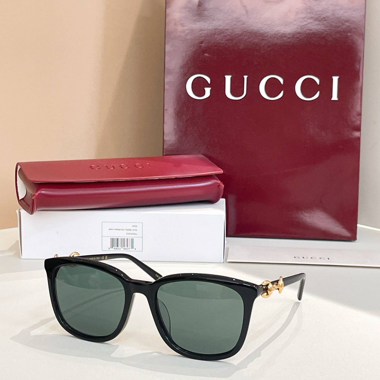 Gucci sunglasses with black frames and green-tinted lenses