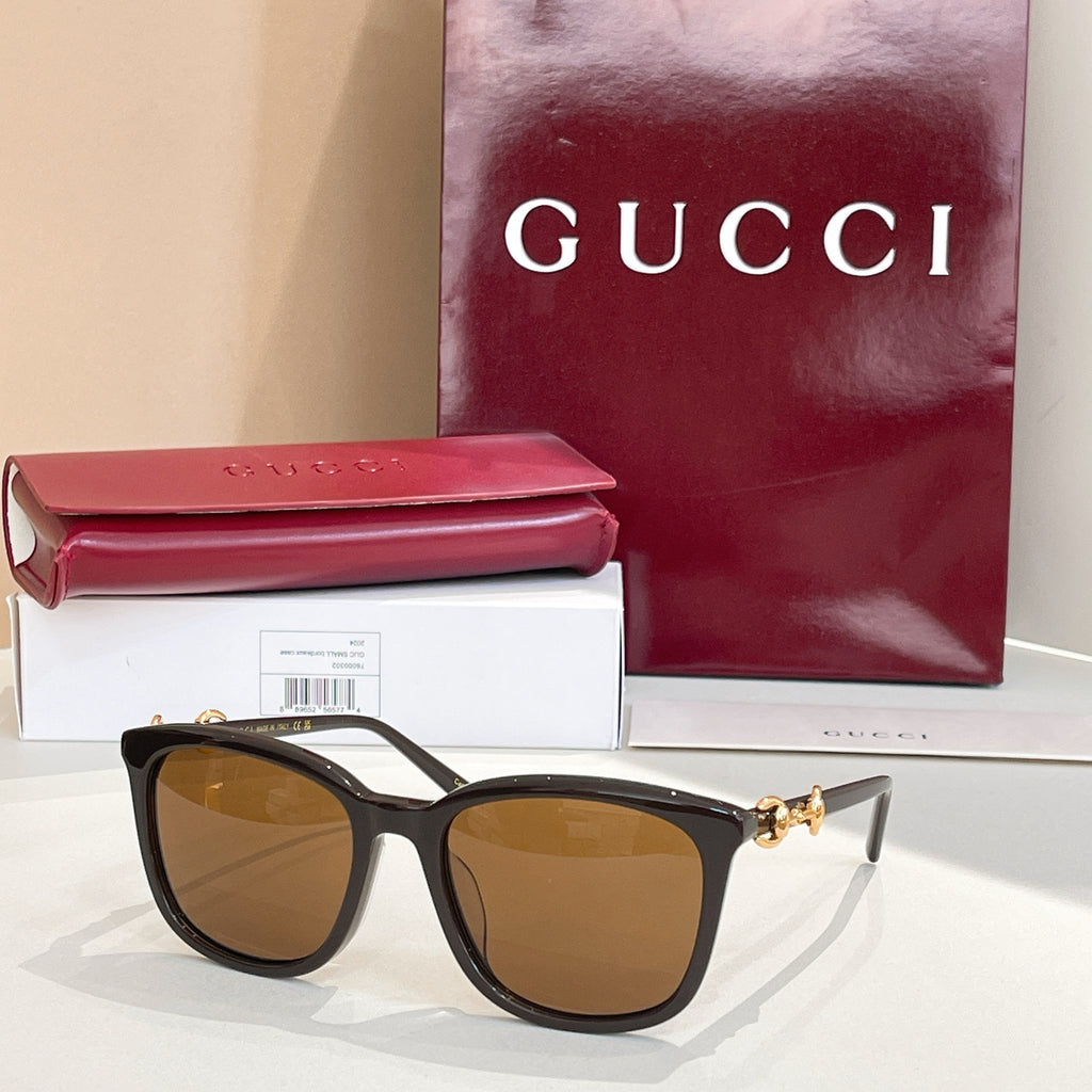 Gucci sunglasses with black frames and amber-brown tinted lenses