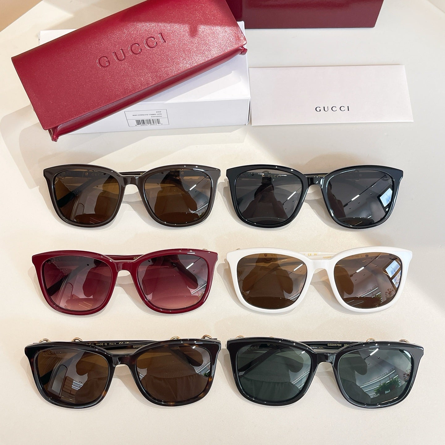 Assorted Gucci sunglasses set with four styles: black, burgundy, white, and dark blue