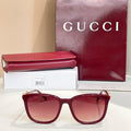 Gucci sunglasses with maroon frames and rose tinted lenses, gold logo temples