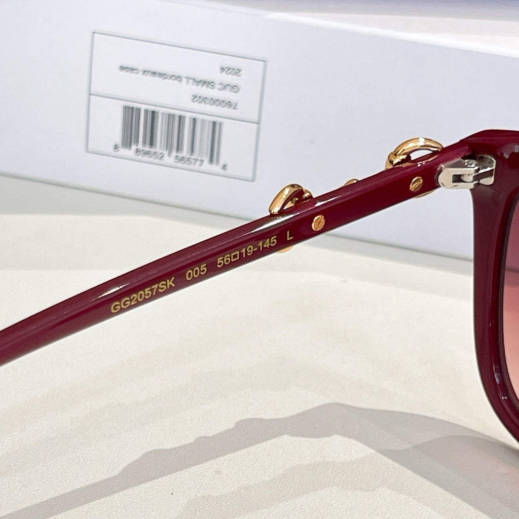 Gucci sunglasses side view with gold 'GU2057SK 005 560-19-145' marking on maroon temple