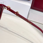 Gucci sunglasses temple close-up with gold logo and 'Made in Italy' text
