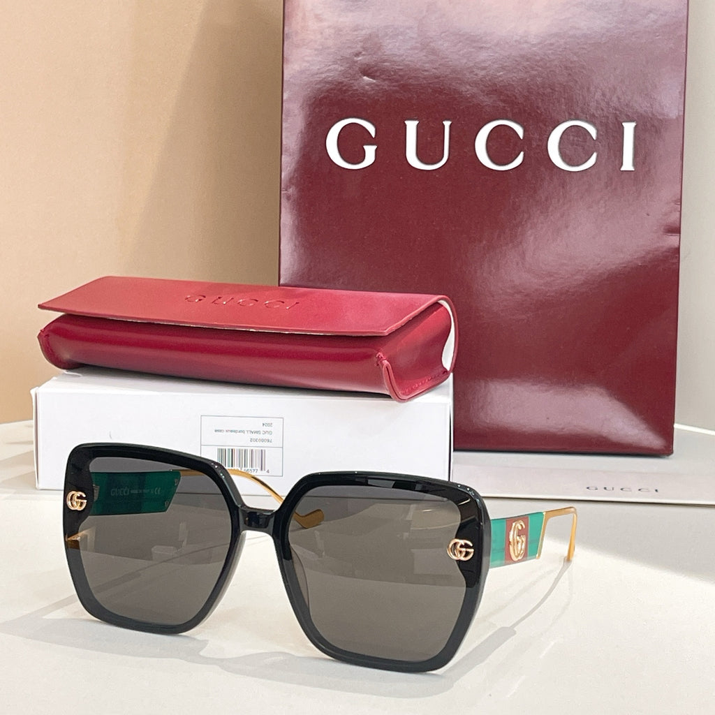 Black square sunglasses with dark green lenses and gold logo accents