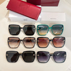 Set of square sunglasses in black, teal, brown, and purple with gold emblems
