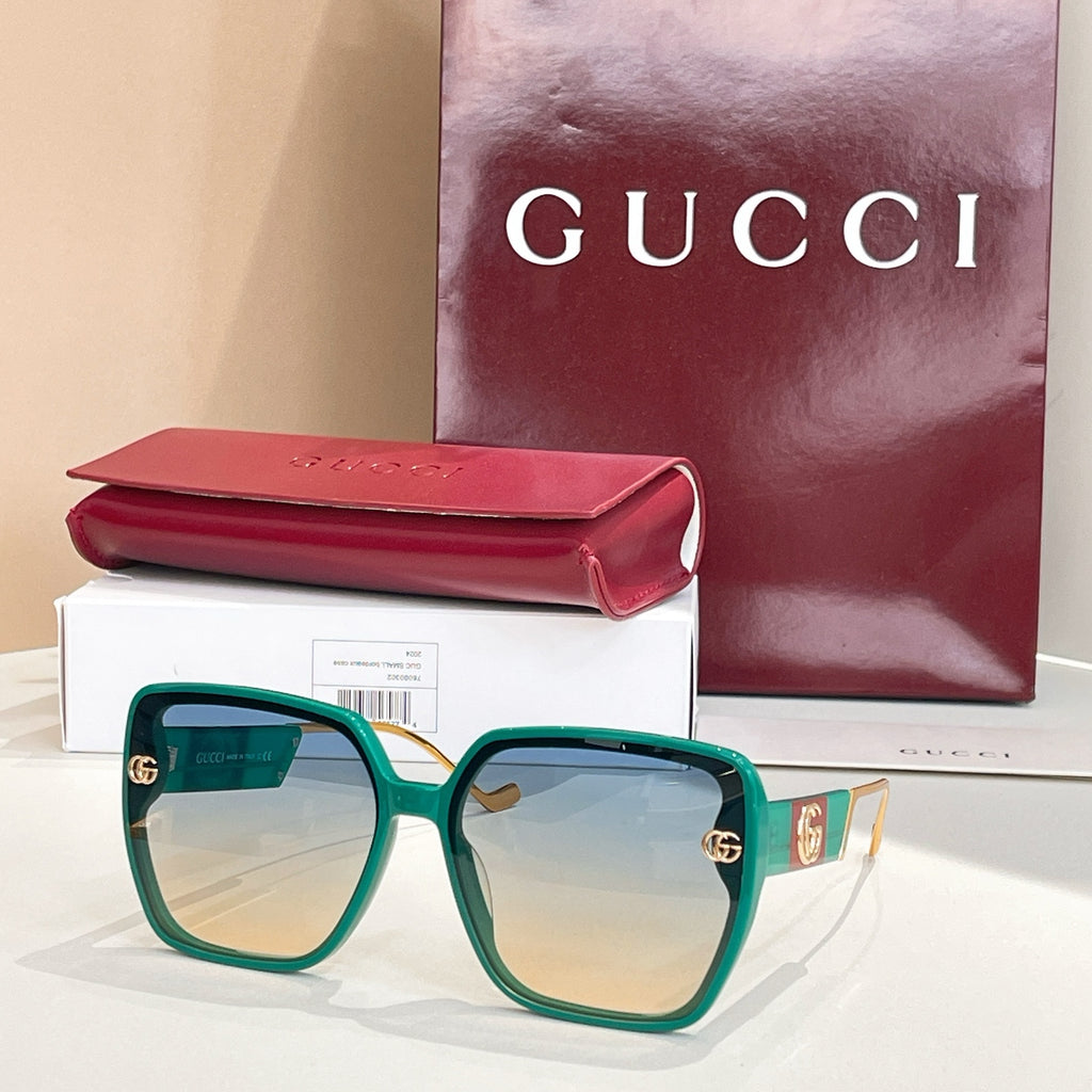 Teal square sunglasses with light gradient lenses and gold logo accents