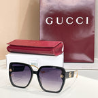 Black square sunglasses with purple-tinted lenses and gold logo accents