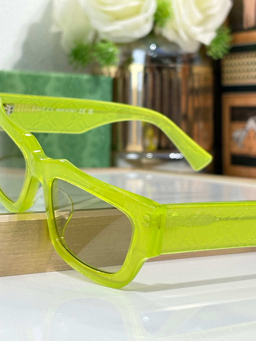 Gucci sunglasses with neon green oversized frames and tinted lenses