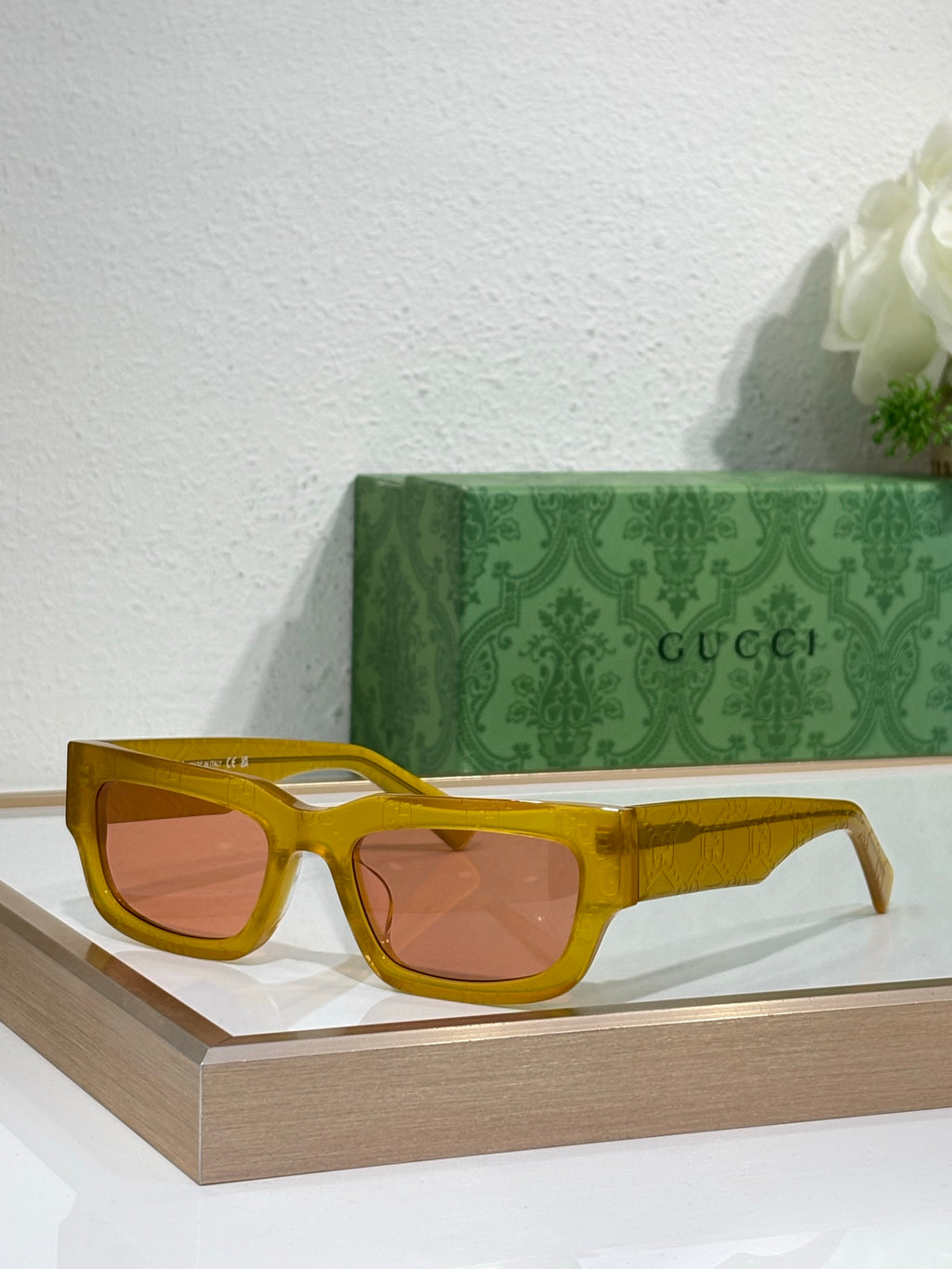 Gucci sunglasses with yellow oversized frames and amber-tinted lenses