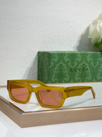 Gucci sunglasses with yellow oversized frames and amber-tinted lenses