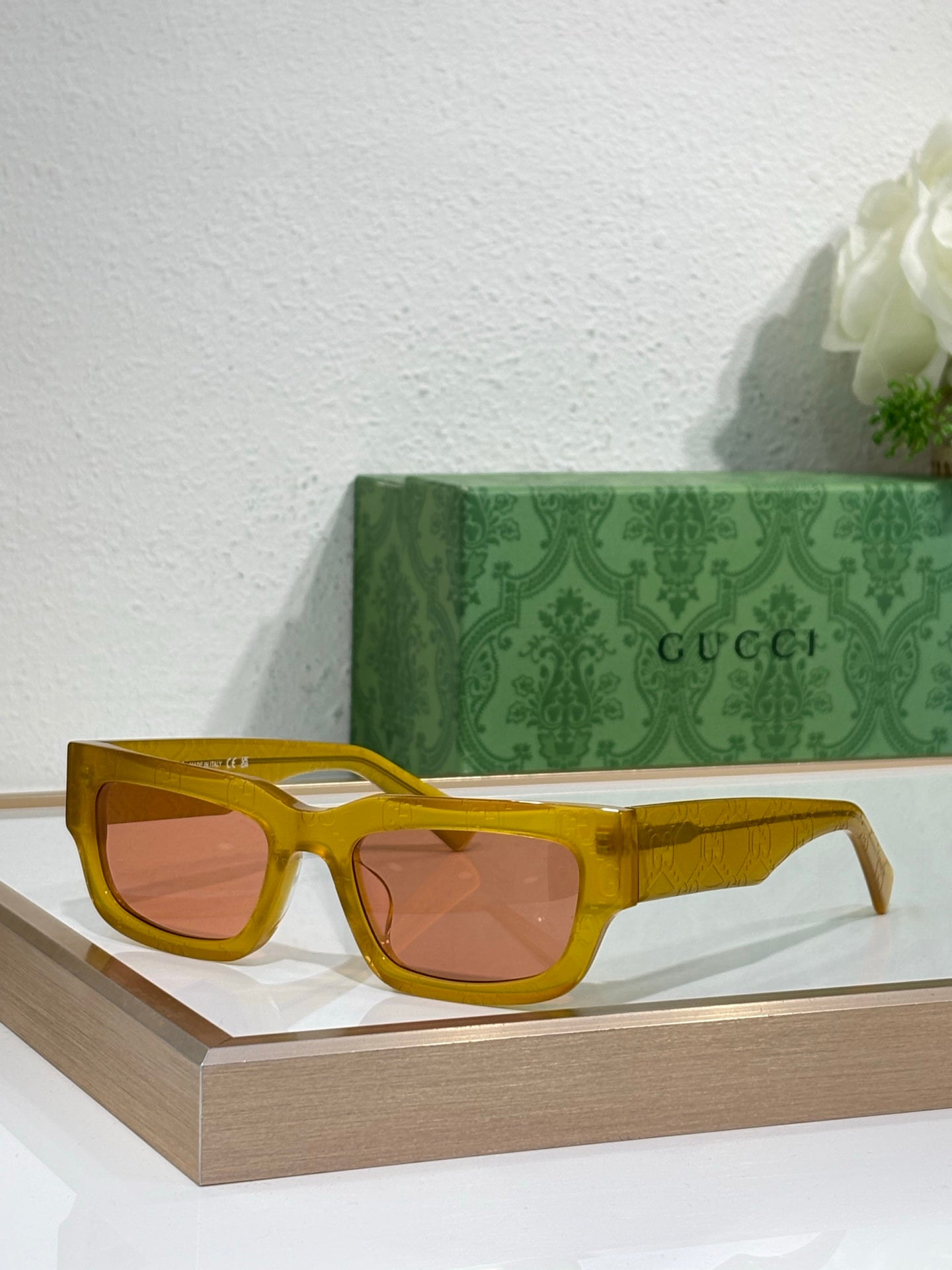 Gucci sunglasses with yellow oversized frames and amber-tinted lenses