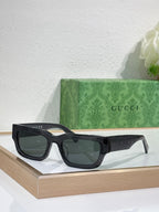 Gucci sunglasses with black oversized frames and dark lenses