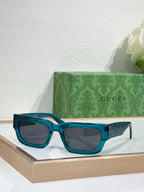 Gucci sunglasses with teal blue oversized frames and dark lenses