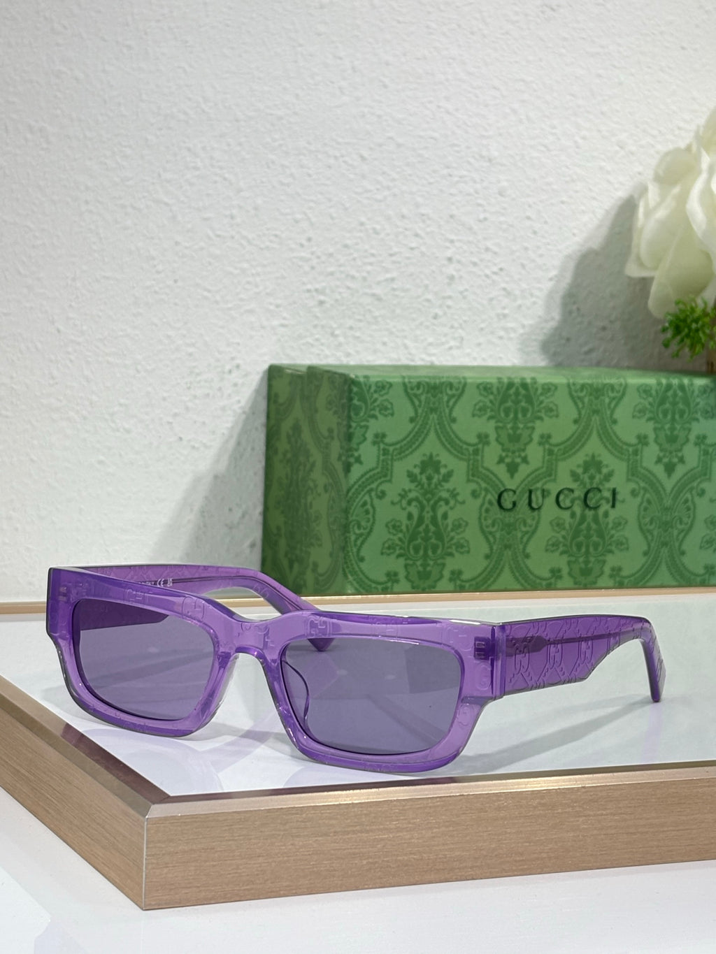 Gucci sunglasses with purple oversized frames and tinted lenses
