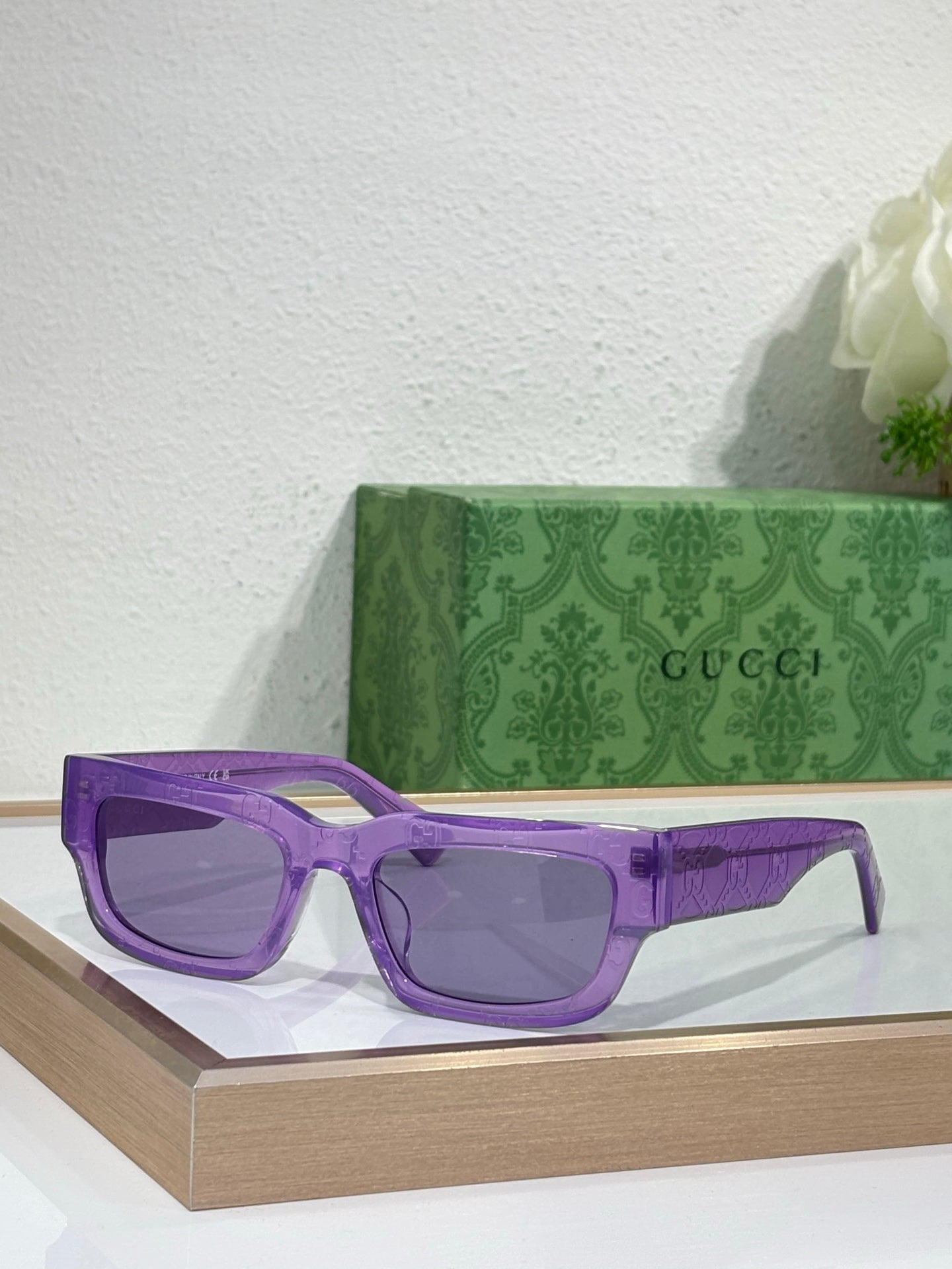 Gucci sunglasses with purple oversized frames and tinted lenses