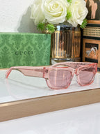 Gucci sunglasses with pale pink oversized frames and rose-tinted lenses