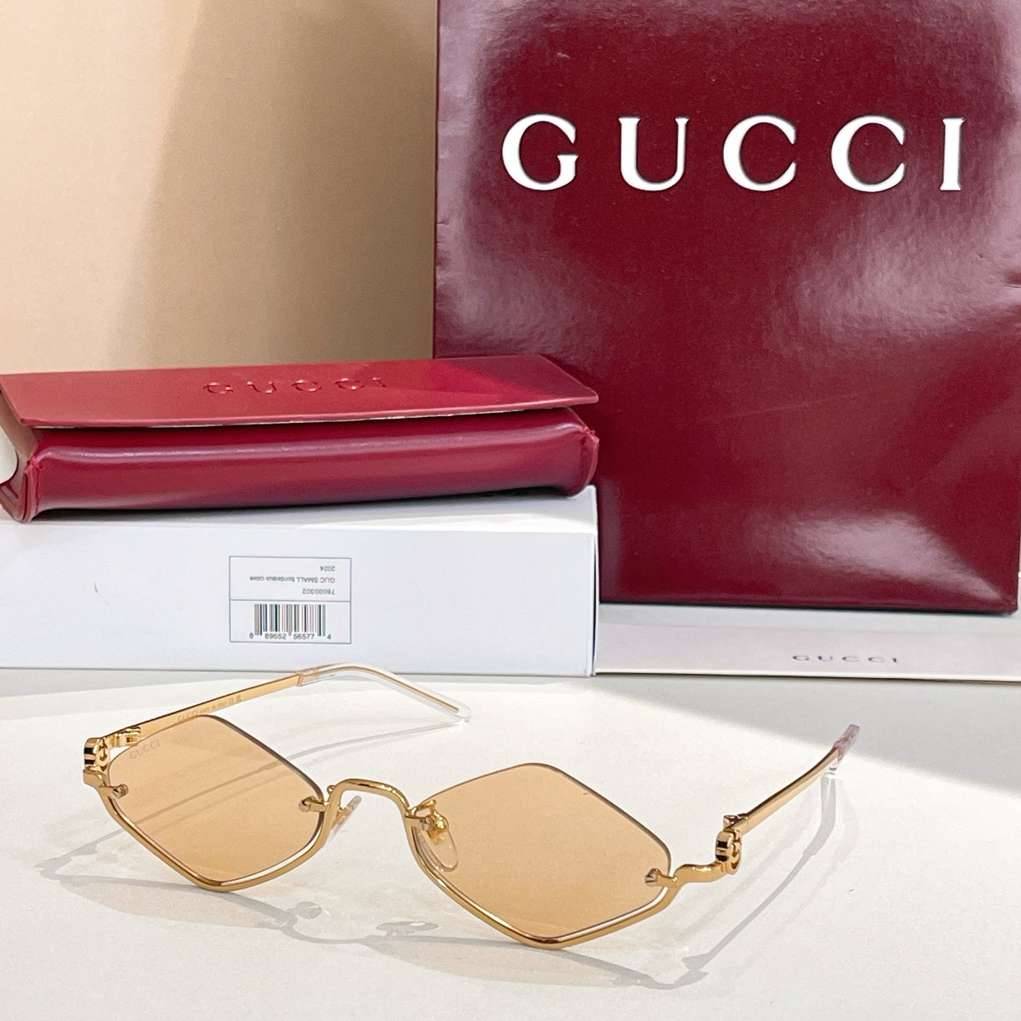 Gold-tone cat-eye sunglasses with tan lenses