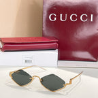 Gold-tone cat-eye sunglasses with dark gray lenses
