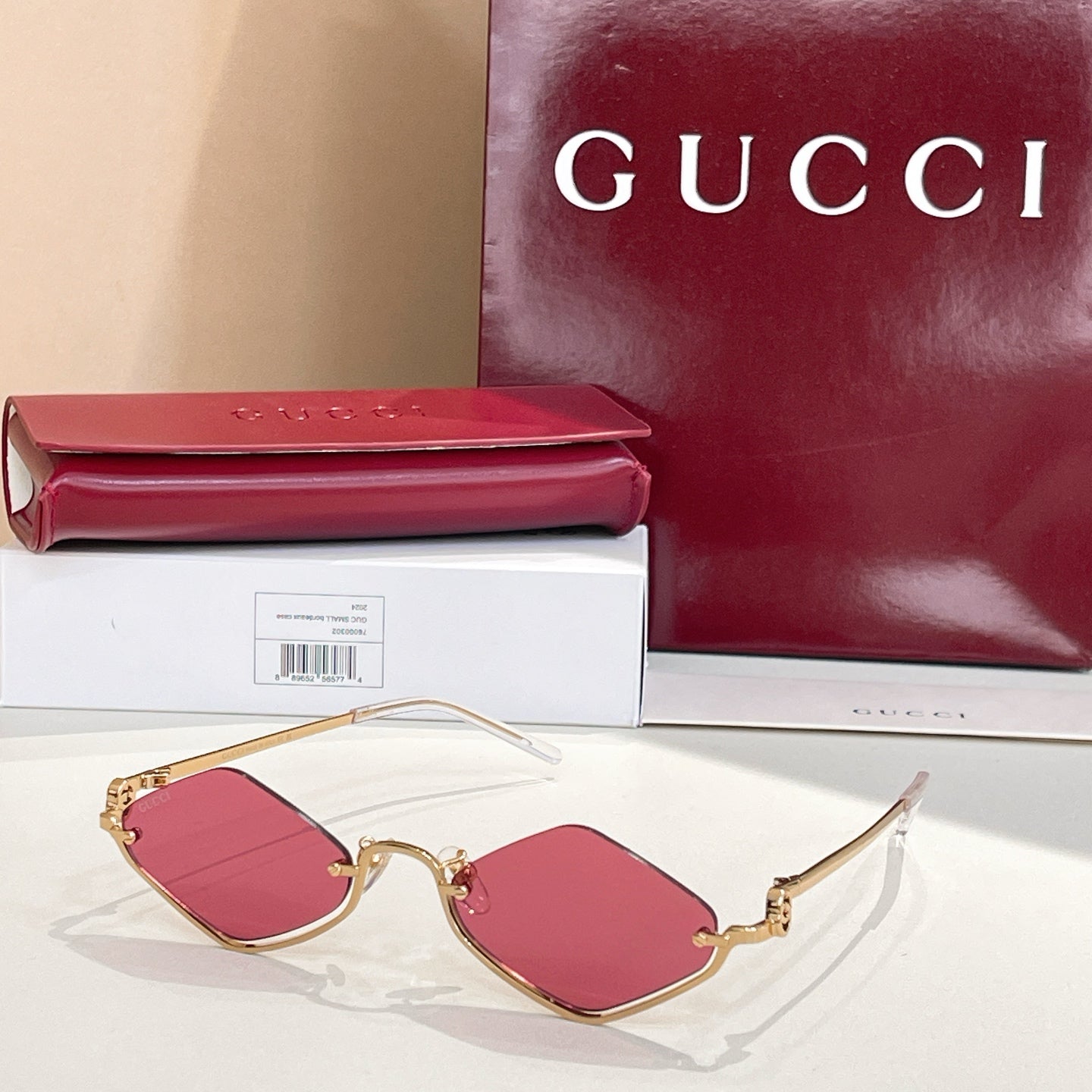 Gold-tone cat-eye sunglasses with pink lenses