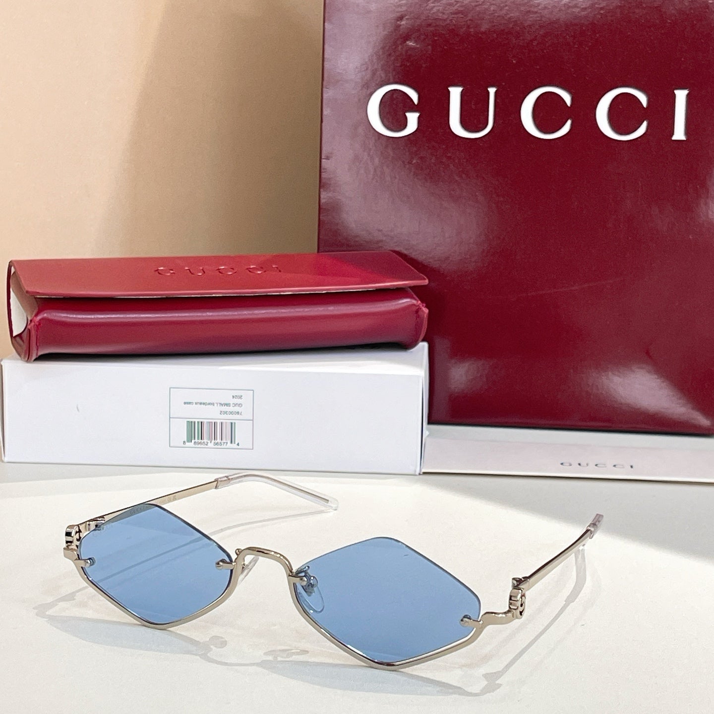 Gold-tone cat-eye sunglasses with blue lenses