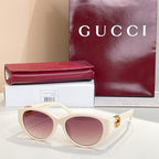 Gucci cat-eye sunglasses with cream frames and mauve-pink lenses