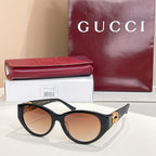 Gucci cat-eye sunglasses with dark tortoise frames and amber-brown lenses
